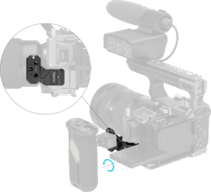 creating ample space between the camera and the handle to not obstruct the usage of the LCD flip screen or the left-side connections.